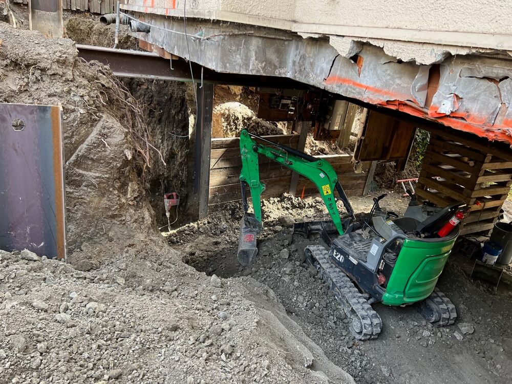 Excavation support beneath an active bridge